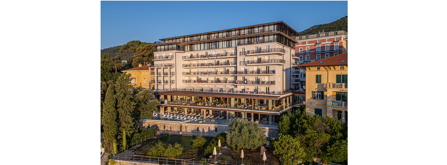 Exterior of the Amadria Park Grand Hotel Opatijska Cvijeta in Opatija at sunset, with balconies, a terrace and garden among historic villas
